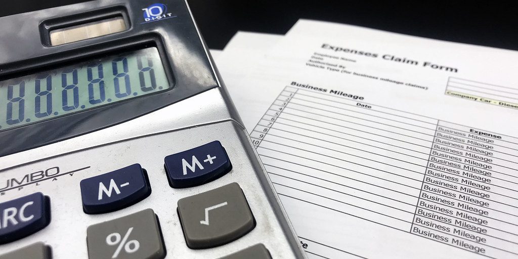 A calculator resting on a printed expenses claim form
