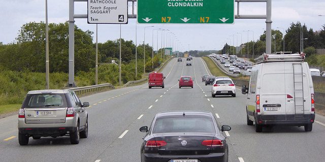 Traffic on a motorway with overhead direction signs
