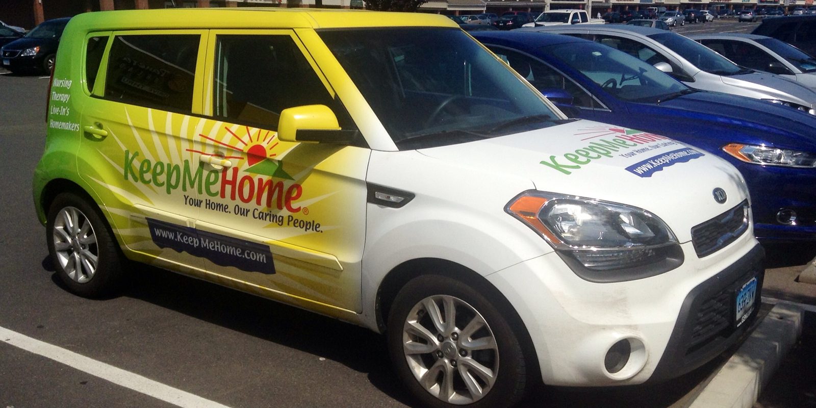 A liveried care service car in a car park