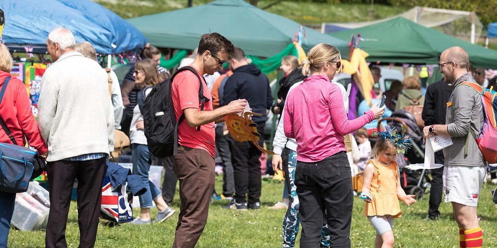 A community charity event with stalls on a green