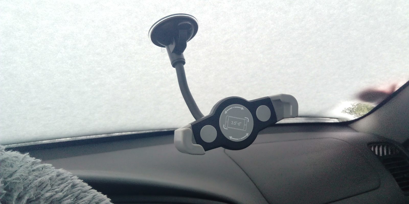A phone cradle mounted on a car windscreen