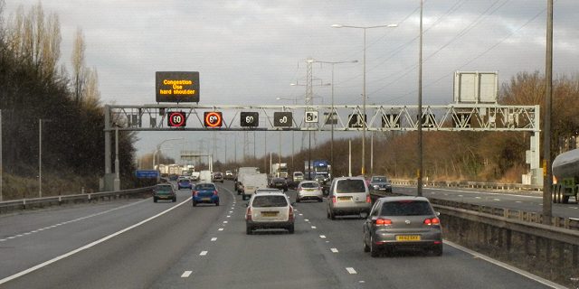 A motorway gantry spanning several lanes of traffic